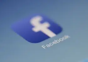 Close-up view of the Facebook app logo on a digital screen with blurred background.